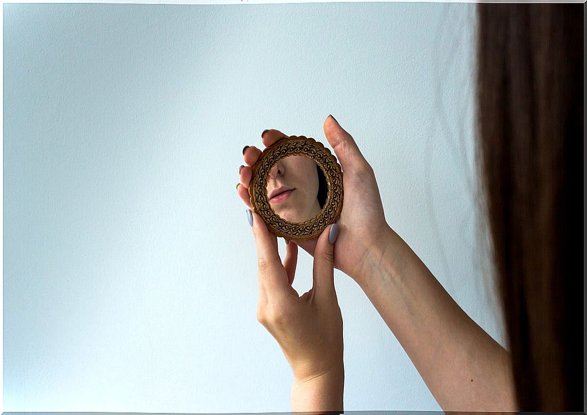 Woman looking at herself in the mirror