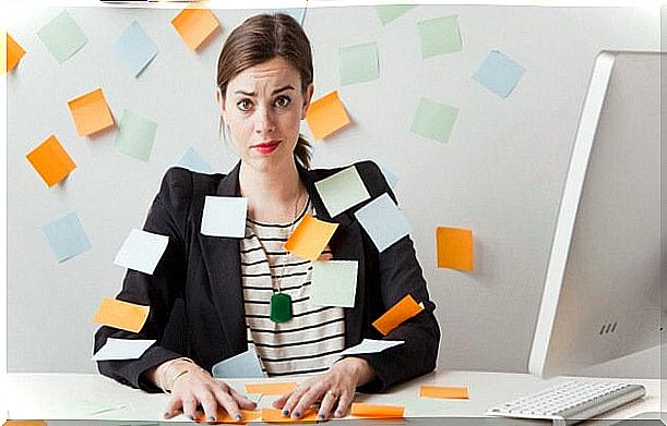 Chronically stressed woman surrounded by post-its thinking about changing jobs