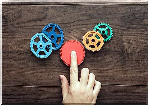 Hand pressing a red wheel