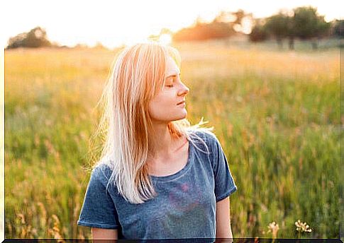 Happy woman with closed eyes symbolizing that you never lack self-love