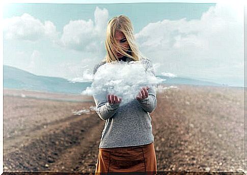 Woman with a cloud in her hands symbolizing catastrophic thinking