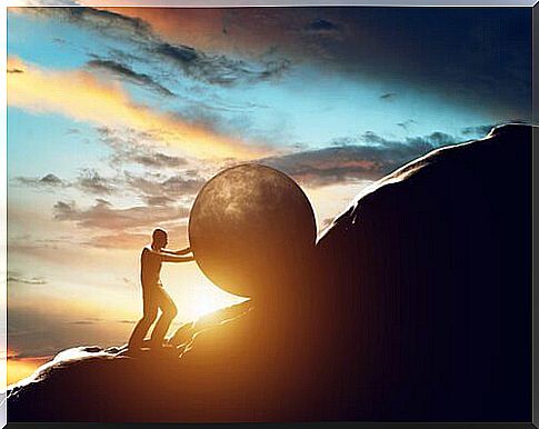 Man climbing a mountain slope with a stone symbolizing how to change a habit