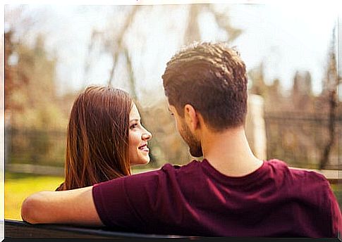 Couple looking at each other on a bench