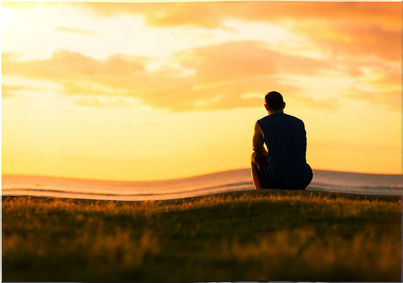 man sitting sunset