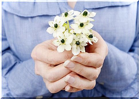 Hands offering flowers