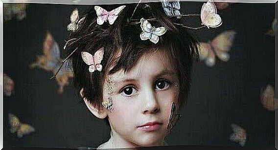 Boy with butterflies on his head