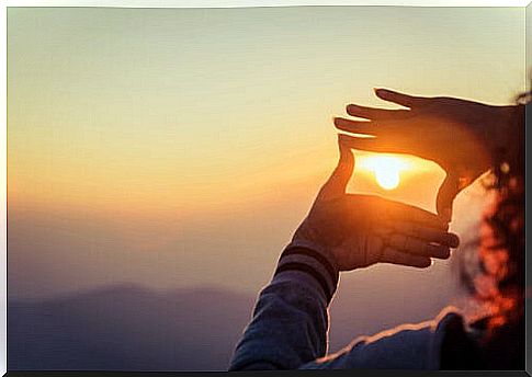 Woman focusing on the sun