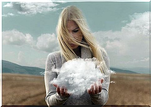 Woman holding a cloud with her hands thinking about walking away to gain perspective