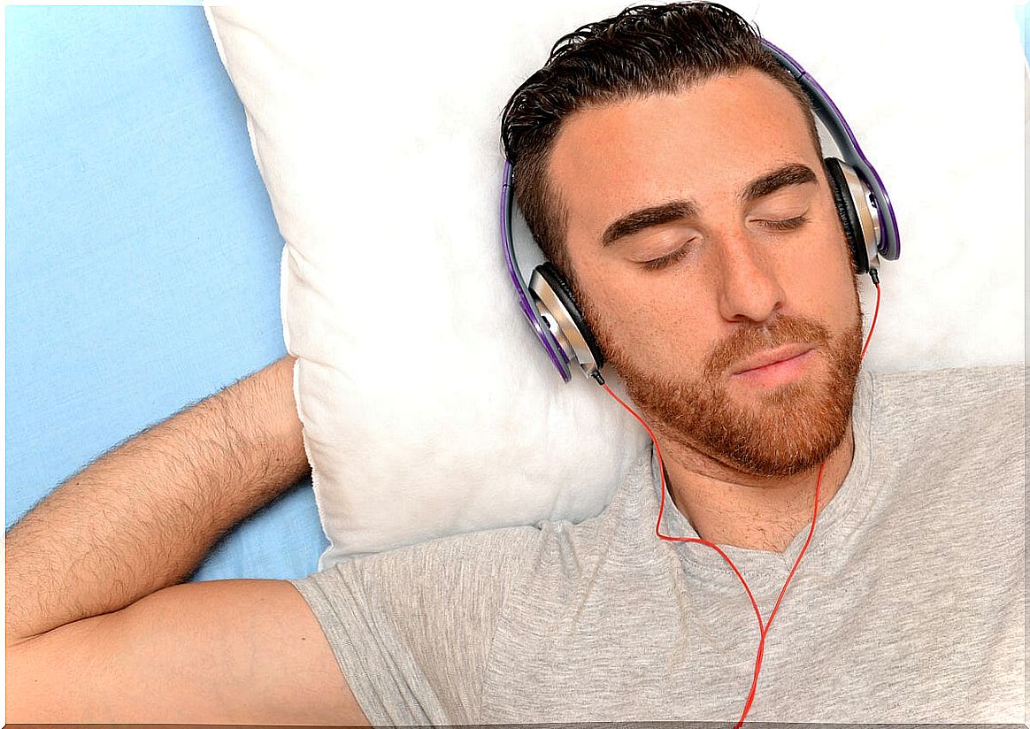 Man listening to music in bed