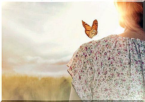 Woman with a butterfly on her shoulder to represent the feeling of inner peace