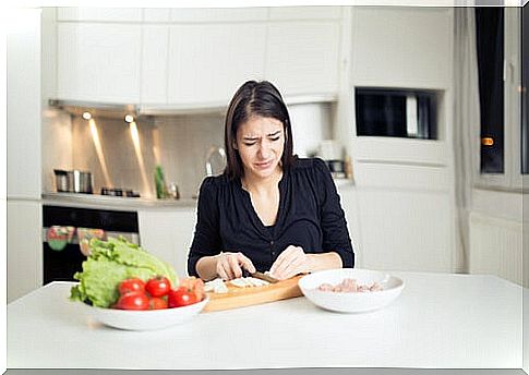 Woman crying while peeling onions