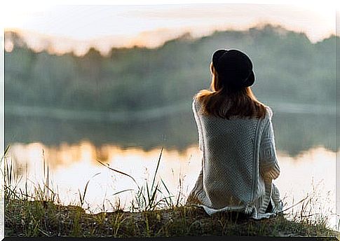 Woman from back looking at the river