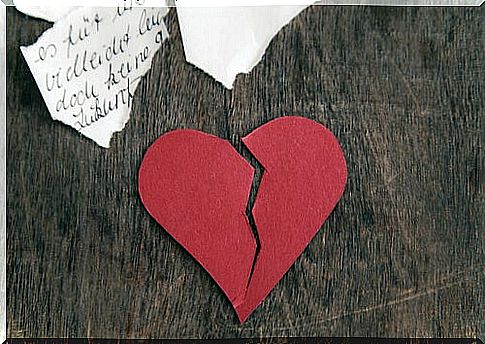 Broken heart on a wooden table symbolizing when an ex rebuilds his life