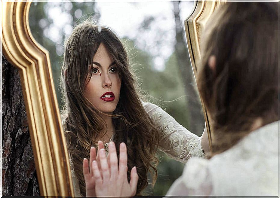 Woman looking in the mirror a tear of blood